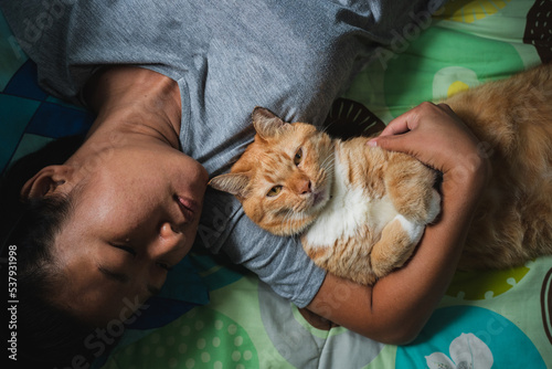 Asian woman hugging a cat. photo