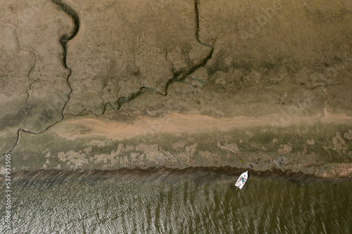 small boat at the edge of the eater of a delta