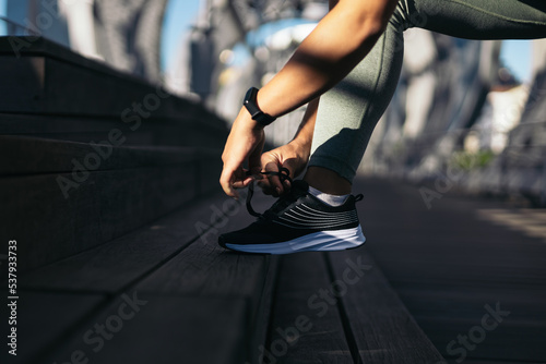 Female runner tying her shoelaces