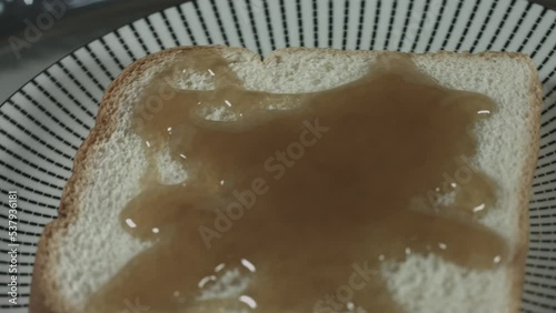 Maple Syrup Drizzles on Pieces of Bread 4K photo