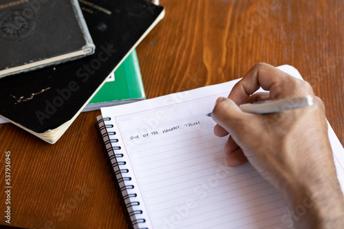 Human hand writing on notebook