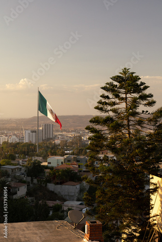 Mexico's Flag in the city of Tijuana overlooking the border  photo