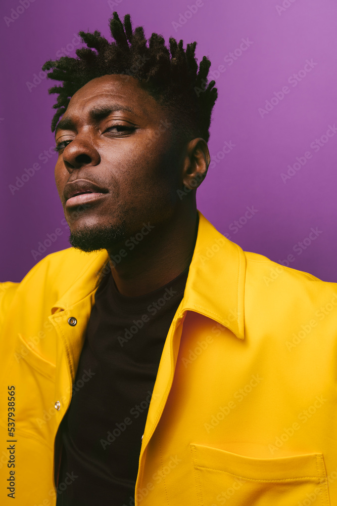 Stylish black man against purple background