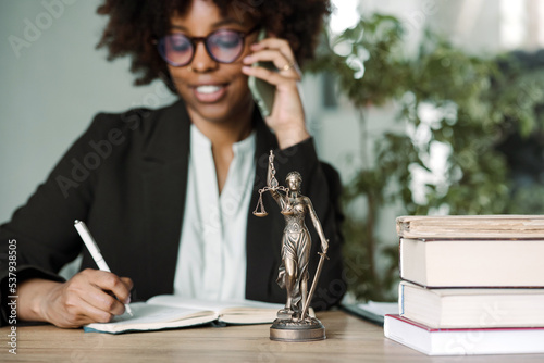 Dark-skinned young woman works in the office  photo