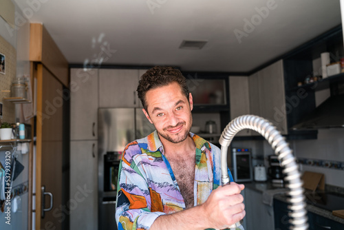 Man cleaning and tidying the kitchen.