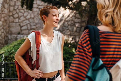 Two students with backpacks talking
