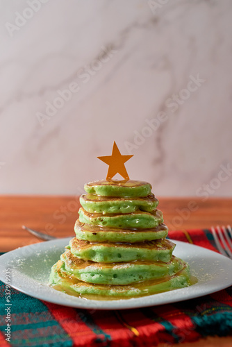 Christmas themed breakfast. Pancakes decorated in the shape of a Christmas tree. photo