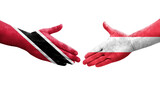 Handshake between Austria and Trinidad Tobago flags painted on hands, isolated transparent image.