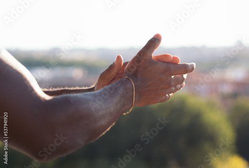 Black man on balcony clapping during the COVID-19 pandemic photo
