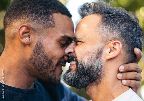 Close up of Multiracial gay couple kissing outdoors photo