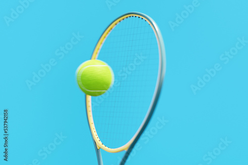Tennis racket hitting a green tennis ball 
