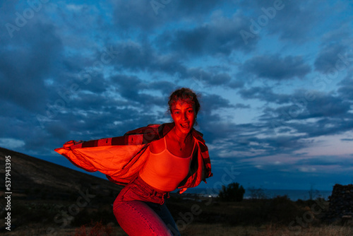 Moving woman lit by red flash photo