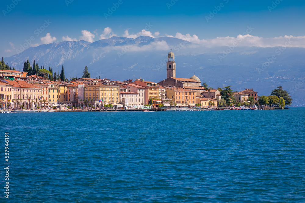 Idyllic lake Garda coastline and mediterranean village with sailboats, Italy Idyllic lake Garda coastline and mediterranean village with sailboats, Italy