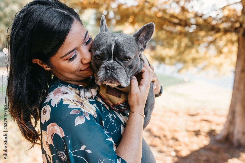 A pregnant woman in the park with her french bulldog
A pregnant woman in the park with her french bulldog