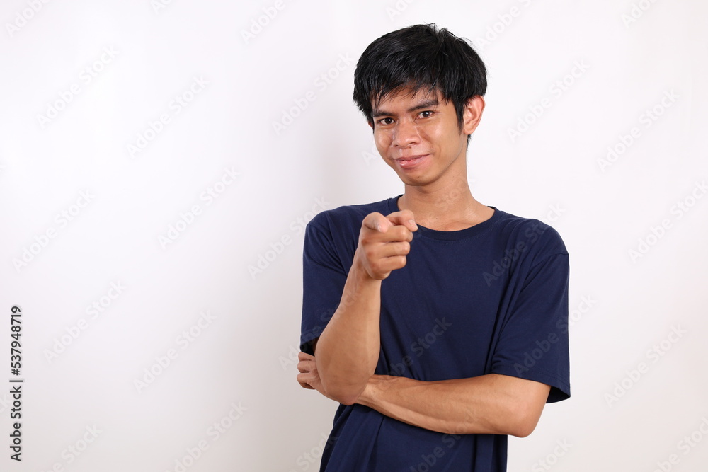 Happy asian young man standing while pointing at the camera. Isolated on white background Happy asian young man standing while pointing at the camera. Isolated on white background