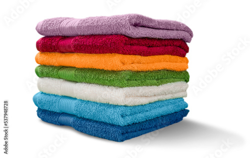 Pile of  fluffy towels on background photo