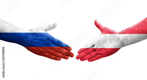 Handshake between Austria and Russia flags painted on hands, isolated transparent image.
