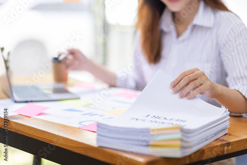 Close up of Business hands working in Stacks of paper files for searching information on work desk workplace office, Office employee working with documents achieves with clips at table in workplace.