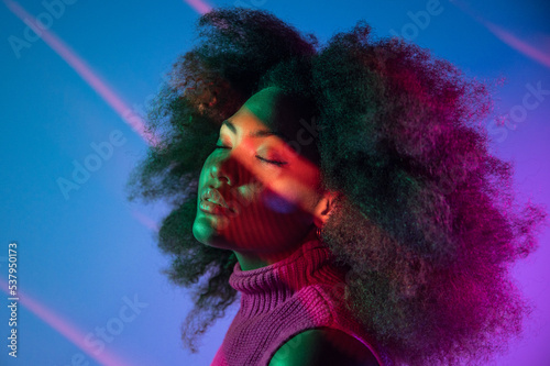 African American model under colorful neon illumination photo