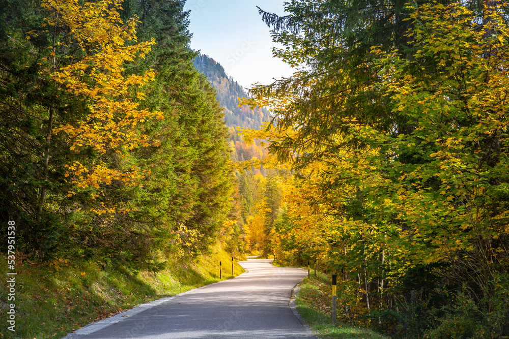 Country road in Alps at dramatic autumn sunrise, Karwendel mountains, Tyrol Country road in Alps at dramatic autumn sunrise, Karwendel mountains, Tyrol