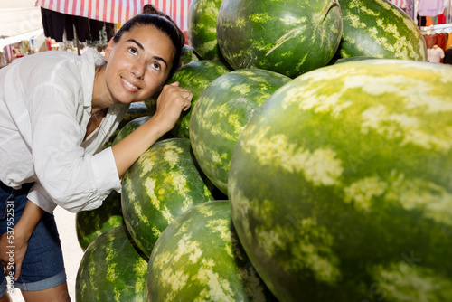 Woman chooses watermelon photo