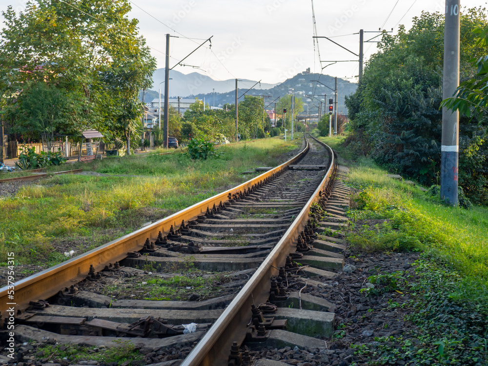 The railroad tracks go up to the mountains. Highlands.. Transport industry. Travel concept. Path symbol. The railroad tracks go up to the mountains. Highlands.. Transport industry. Travel concept. Path symbol.