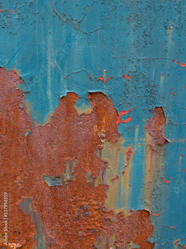 peeling multi-colored paint over rusty metal photo