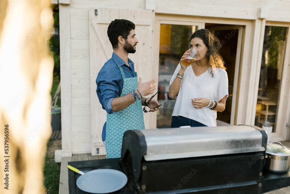Two Friends Standing Next To The Grill Two Friends Standing Next To The Grill