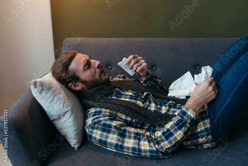 Guy with cold at home. photo