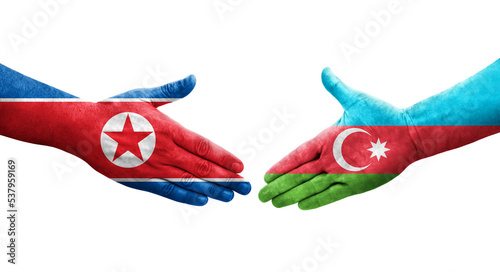 Handshake between Azerbaijan and North Korea flags painted on hands, isolated transparent image.