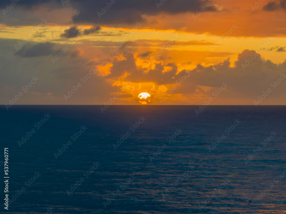 Drizzly moody sunrise seascape with cloud filled sky