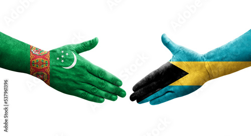 Handshake between Bahamas and Turkmenistan flags painted on hands, isolated transparent image.