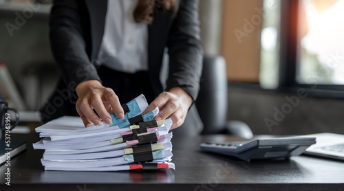 Print op canvas Businesswoman hands working in Stacks of paper files for searching and checking