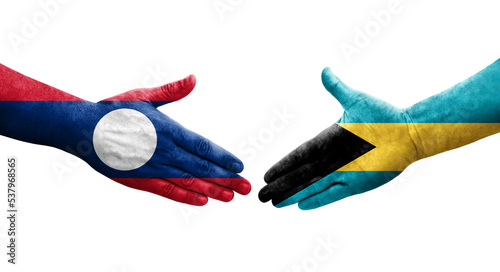 Handshake between Bahamas and Laos flags painted on hands, isolated transparent image.