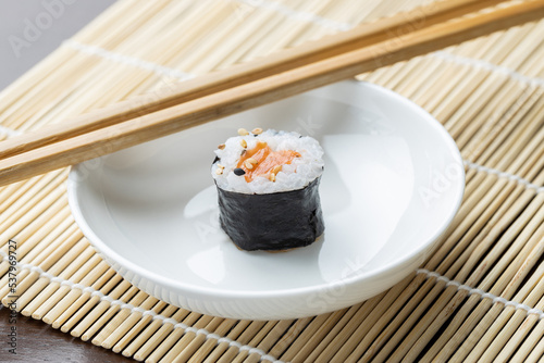 Salmon sushi roll on a white dish at a Japanese restaurant