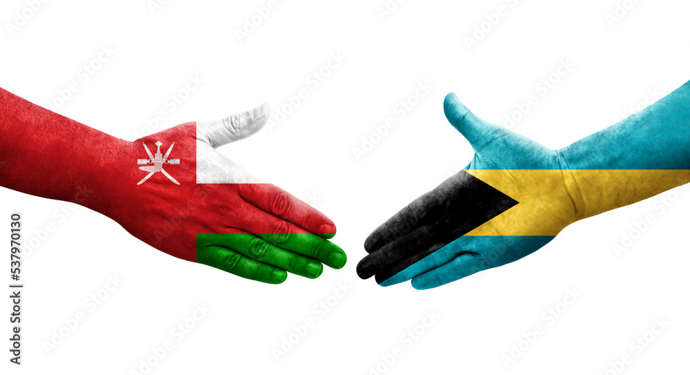 Handshake between Bahamas and Oman flags painted on hands, isolated transparent image.