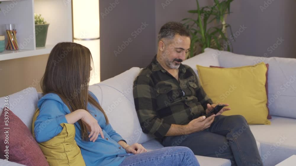 Family problems. The woman does not trust her husband. Confidence issue.
The woman suspects her husband, takes the phone from her hand, checks it and gives it back.
