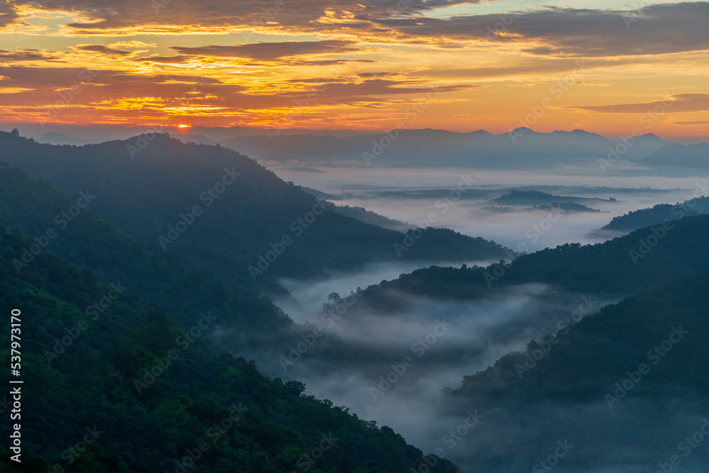 Layers of mountains with morning sunrise at Loei province,Thailand.Viewpoint from Phu Bor Bid with fog in early morning.Winter atmosphere.