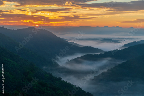 Layers of mountains with morning sunrise at Loei province,Thailand.Viewpoint from Phu Bor Bid with fog in early morning.Winter atmosphere.