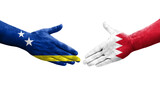 Handshake between Bahrain and Curacao flags painted on hands, isolated transparent image.