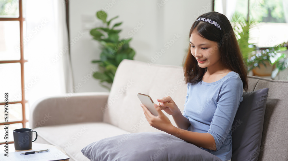 Work from home concept, Business women is reply email on smartphone while working remotely at home Work from home concept, Business women is reply email on smartphone while working remotely at home