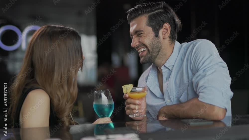 Asian couple having a good time together enjoying good vibe drinking cocktail and talking about daily life and future in a sky lounge and bar in Bangkok city	
