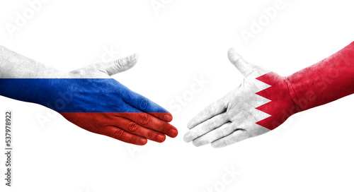 Handshake between Bahrain and Russia flags painted on hands, isolated transparent image.