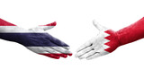 Handshake between Bahrain and Thailand flags painted on hands, isolated transparent image.