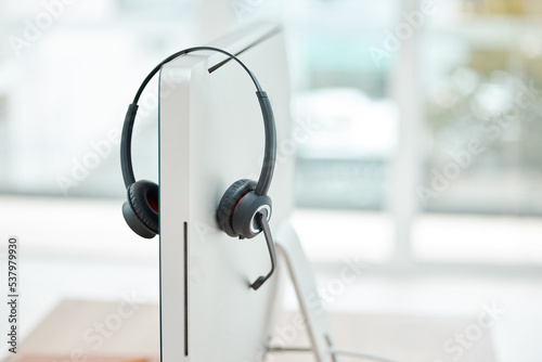 Headphone, contact us and empty office at call center with computer for online customer service or support. Helpdesk hotline assistance gadgets and crm equipment in workplace or telemarketing office