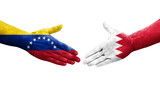 Handshake between Bahrain and Venezuela flags painted on hands, isolated transparent image.