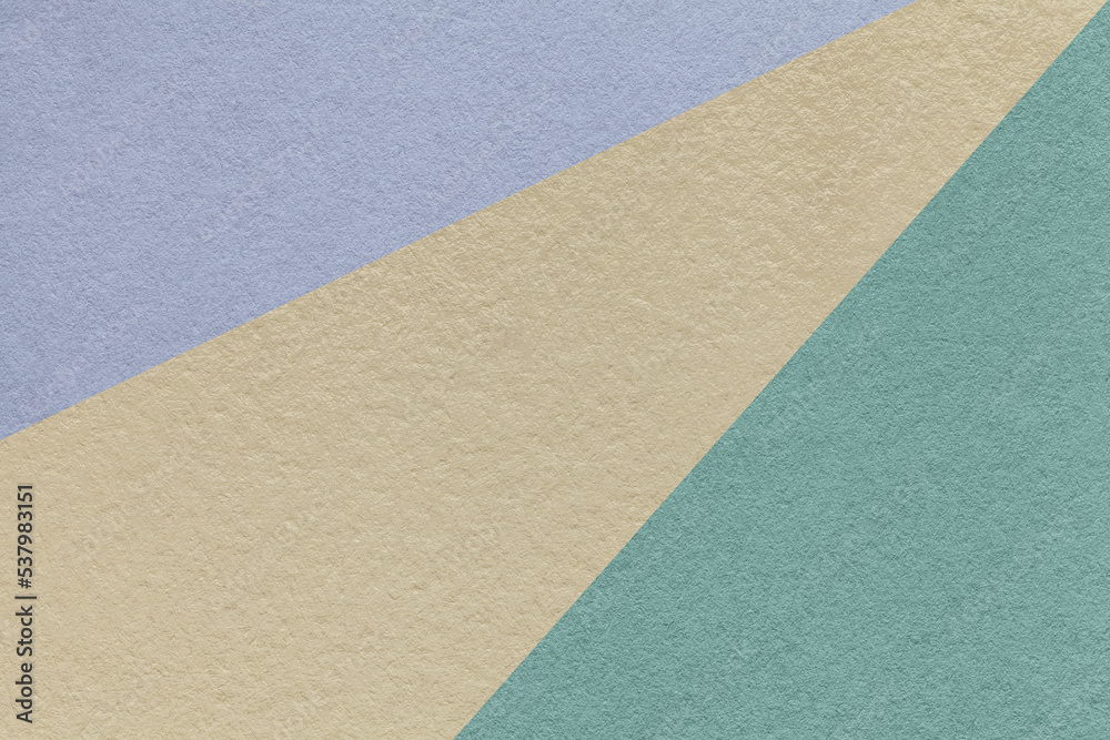 Texture of old craft beige, blue and very peri color paper background, macro. Vintage abstract cerulean cardboard.