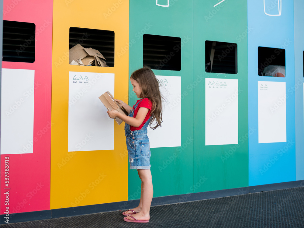 National Recycling Day. Girl dumping cardboard in bank for reduce ...