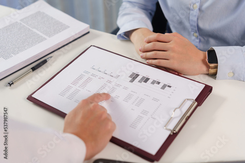 Business concept, Business colleague pointing on document to explain financial data to partner