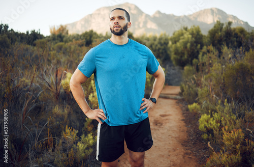 Nature hiking, run and fitness workout of a man on a calm morning on a mountain park running trail. Health exercise, training and healthy person outdoor on walking or runner break with mountains view